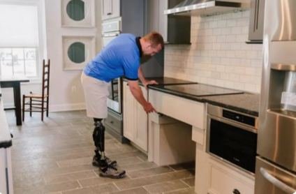 Veteran with prosthetic legs in his kitchen